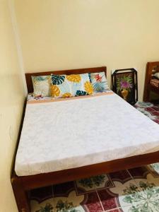 a bed in a room with a white mattress at Jeremias Transient Patar Bolinao near WhiteBeach LightHouse in Bolinao