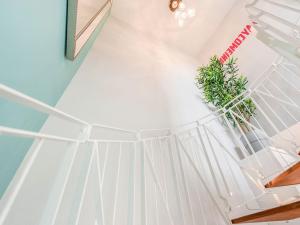 a white staircase with a potted plant on it at Ay Come Inn in York