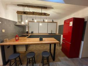 a kitchen with a table and a red refrigerator at Casa Divisadero en la Patagonia in Coihaique