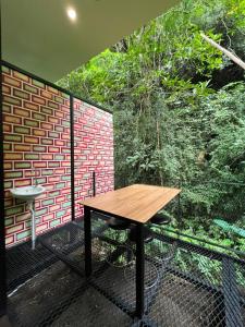 a wooden table and chairs on a balcony at Xscape Tambun in Ipoh