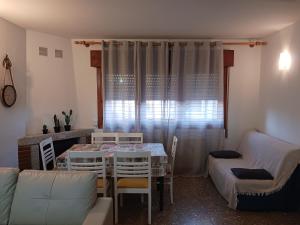 a living room with a table and a couch at La Casita de Cabanillas. Cabanillas de la Sierra. in Cabanillas de la Sierra