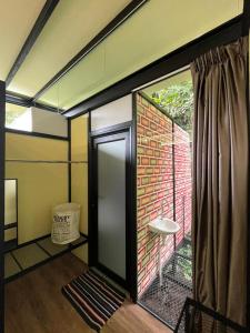 a bathroom with a window and a brick wall at Xscape Tambun in Ipoh