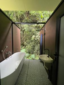 a bathroom with a bath tub and a sink at Xscape Tambun in Ipoh