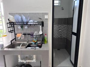 a kitchen with a sink and a shower at Homestay Mama, Kota Bharu in Kota Bharu +13 photos