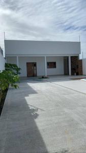 a large white building with a large door at CASA K in Barra de São Miguel