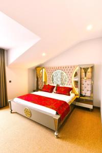 a bedroom with a large bed with red pillows at Ghan Hotel in Istanbul