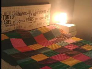 a bed with a colorful blanket on top of it at Bloque de Viviendas in Ibiza Town