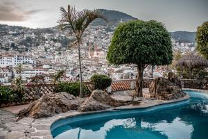 a swimming pool with a view of a city at Hotel Cielito Lindo, Taxco in Taxco de Alarcón