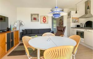 a kitchen and living room with a table and chairs at Awesome Apartment In Allinge in Allinge