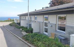 a house on the side of a street at Awesome Apartment In Allinge in Allinge +14 photos