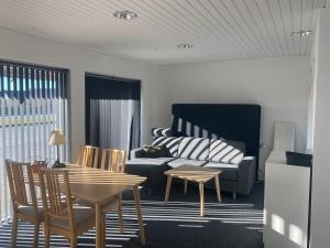 a living room with a couch and a table at Parallalvej 58B-A in Hvide Sande