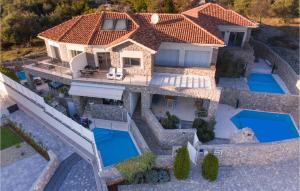 an aerial view of a house with two swimming pools at Nice Home In Krk With Wifi in Krk