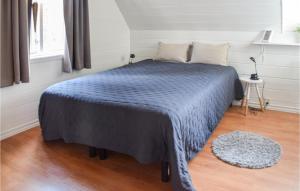 1 dormitorio con 1 cama con manta azul en 2 Bedroom Cozy Home In Halden en Halden