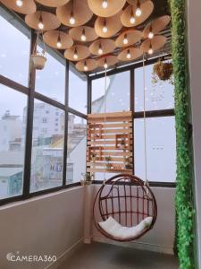 a room with a chair in front of a window at City Pass Da Lat in Da Lat