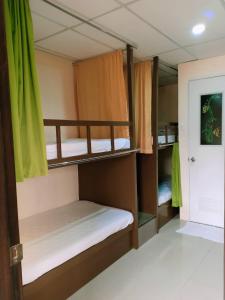 a room with two bunk beds and a door at Anton's Inn in Balanga