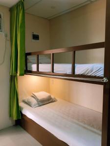 a couple of bunk beds in a room at Anton's Inn in Balanga