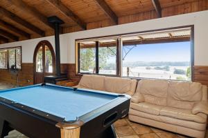 a pool table in a living room with a couch at Augusta Sheoak Chalets in Augusta