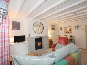 a living room with a couch and a fireplace at Ty Hydref in Beaumaris