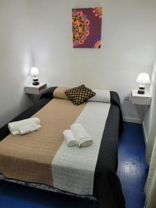 a bedroom with a large bed with two pillows on it at Departamento Desire in Puerto Deseado