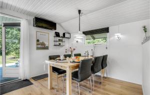 a dining room with a table and chairs at 3 Bedroom Gorgeous Home In Ringkøbing in Ringkøbing