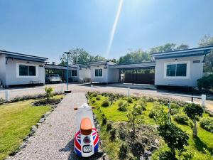 a toy car sitting in the yard of a house at Baan Ruay Suk Resort, Lopburi in Lop Buri