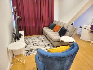 a living room with a couch and two tables at Garland City Centre Apartment, Crayford-Dartford in Crayford