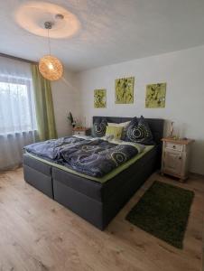 a bedroom with a large bed in a room at Ferienwohnung Walter Gluche in Pittenhart