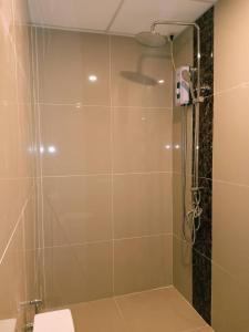 eine Dusche mit Glastür im Bad in der Unterkunft Anton's Inn in Balanga