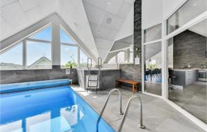 a swimming pool in a house with a bathroom at 8 Bedroom Amazing Home In Ringkbing in Ringkøbing