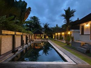 a swimming pool in the backyard of a house at Agung Village in Tanah Lot