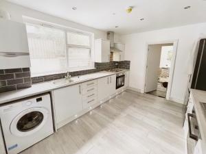 una cucina con lavatrice e asciugatrice di Modern Room in Centrally Located Apartment - Room 4 a Londra