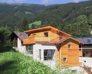 a wooden house on the side of a hill at der Wildbachhof - Contactless check in in Zell am See