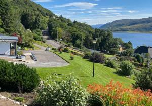 a park with a view of a lake and mountains at Foinaven House in Ullapool