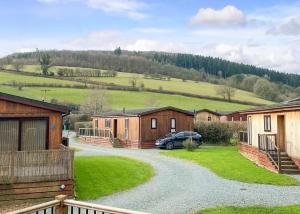 a car parked in front of a row of houses at Clun Valley Lodges in Clunton