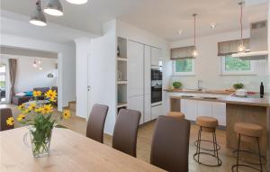 a kitchen and dining room with a table and chairs at Awesome Home In Krsan With Wifi in Kršan