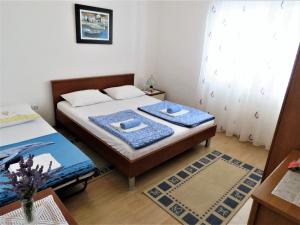a bedroom with a bed with two pillows on it at House Franica in Zadar