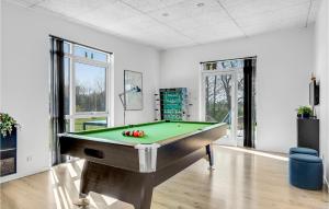 a room with a pool table with apples on it at Nice Home In Haderslev With 5 Bedrooms, Sauna And Wifi in Knud