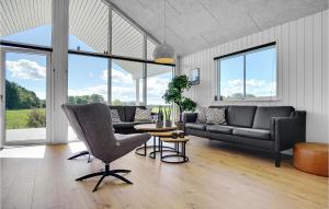 a living room with a couch and a table at Stunning Home In Stege With Sauna in Stege