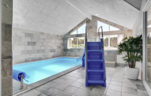 a swimming pool with a blue slide in a house at Stunning Home In Stege With Sauna in Stege