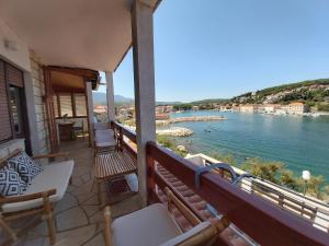 a balcony of a house with a view of the water at Apartment Next to the sea in Jelsa