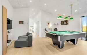 a living room with a pool table and a couch at Nice Home In Hadsund With Sauna in Hadsund