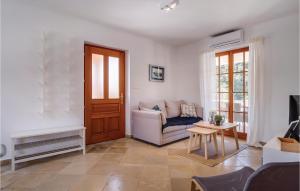 a living room with a couch and a table at Beautiful Home In Sveti Jakov With Kitchen in Sveti Jakov