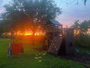 a playground with a slide in the grass at Arritola B and B Ranch in Homestead