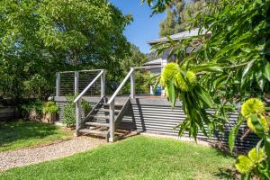 a wooden staircase leading to a deck in a yard at Clara Luce` in Bright