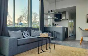 a living room with a couch and a table and a kitchen at Statendam 16 in Ohé en Laak