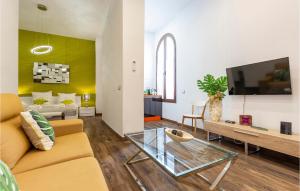a living room with a couch and a tv at Stunning Apartment In Sevilla With Wifi in Seville