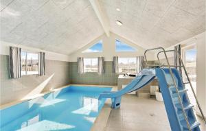 a indoor swimming pool with a slide in a house at 8 Bedroom Stunning Home In Vejby in Vejby