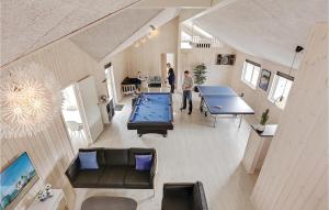 a man standing in a room with two ping pong tables at 8 Bedroom Stunning Home In Vejby in Vejby