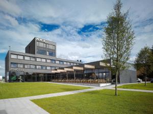 a building with tables and chairs in front of it at Pivotel MMX in Dobřichovice
