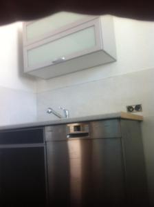 a kitchen with a sink and a microwave at Ferienwohnungen Kolsdorf B in Braunlage